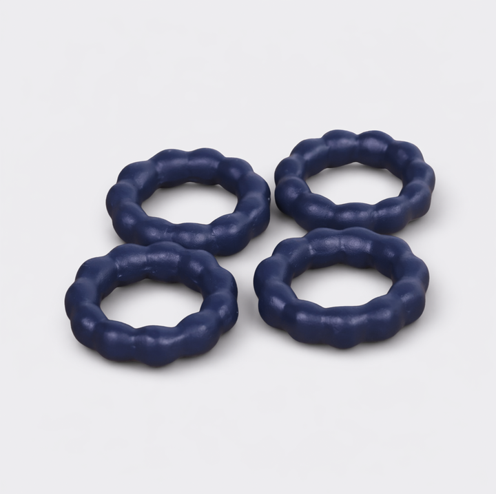  Beaded terracotta napkin rings styled on a festive dining table with cloth napkins
