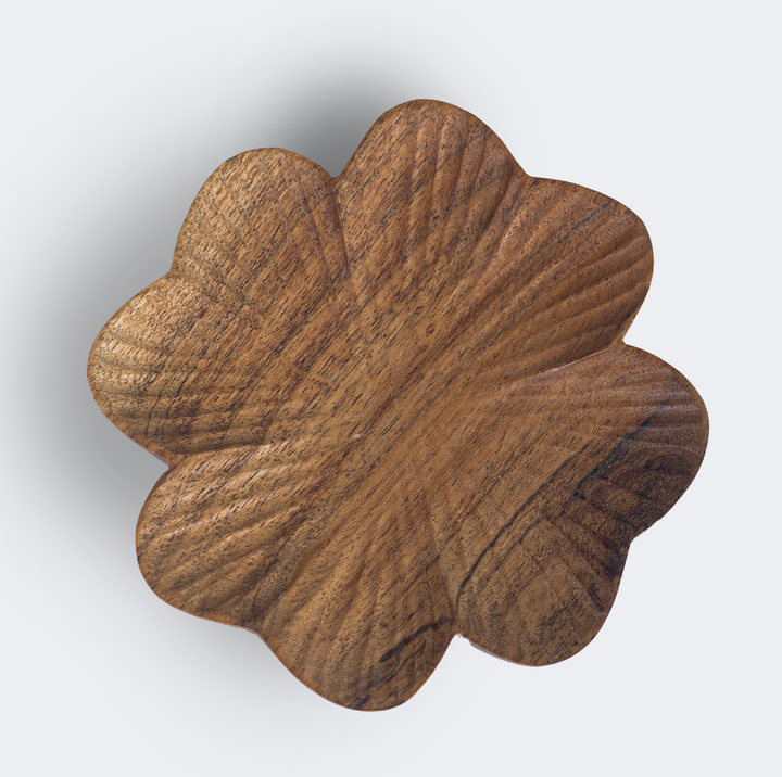  Close-up of hand-carved textured surface and natural wood grain on a scalloped wooden dish