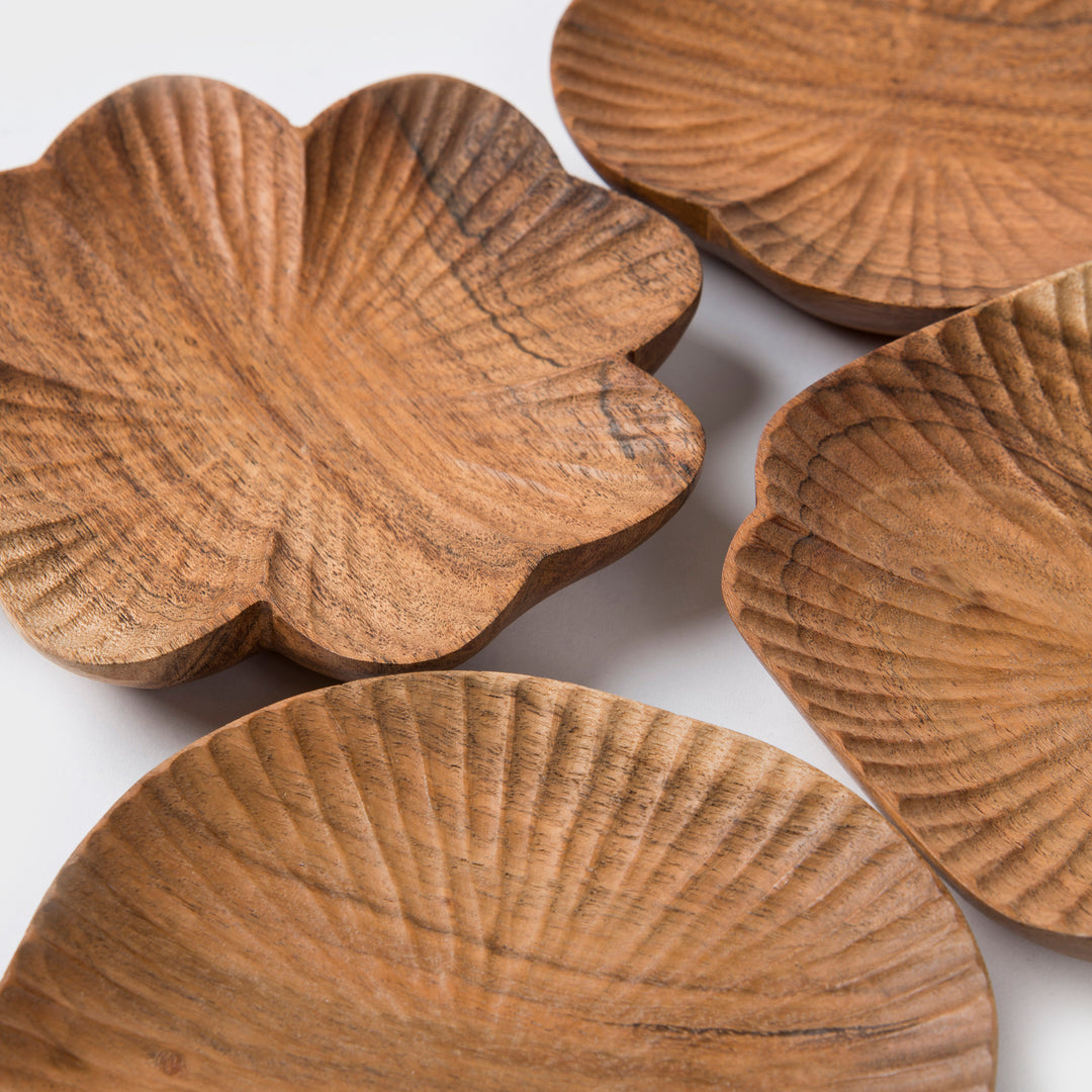  Close-up of hand-carved textured surface and natural wood grain on a scalloped wooden dish
