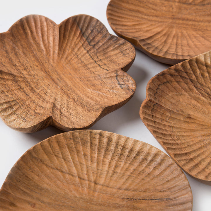  Close-up of hand-carved textured surface and natural wood grain on a scalloped wooden dish