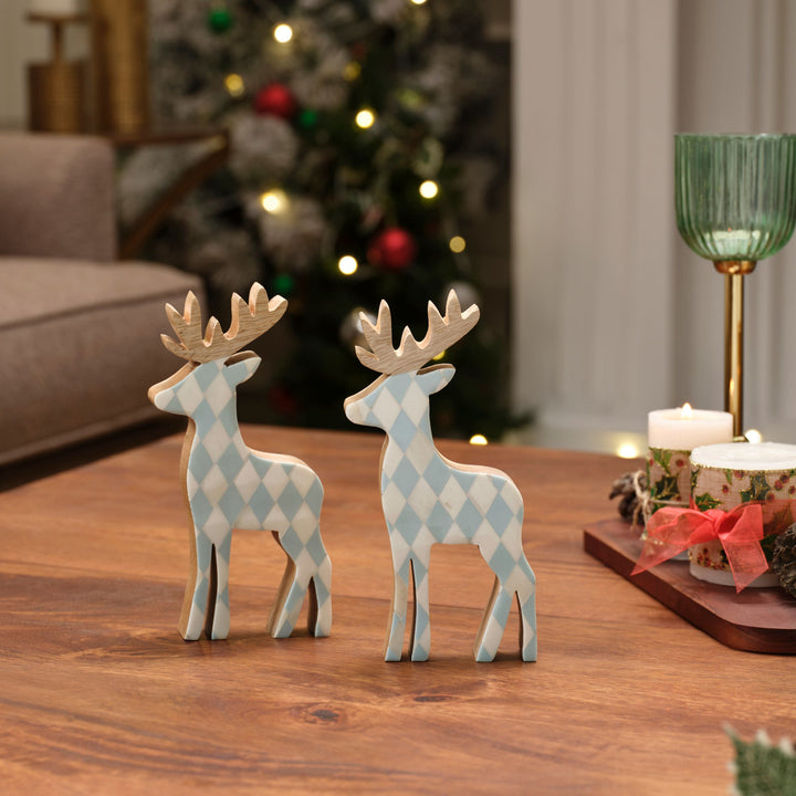  Teal blue and white diamond bone inlay reindeer figurines displayed on a holiday mantelpiece