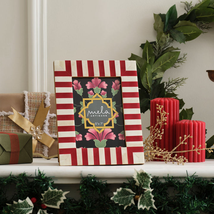 Candy cane red and white bone inlay picture frame displayed on a festive holiday mantelpiece