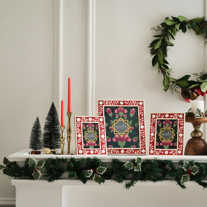 Red and white floral bone inlay picture frame displayed on a festive holiday mantelpiece  
