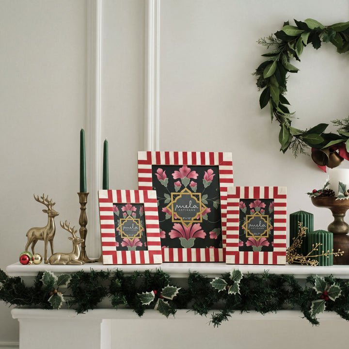 Candy cane red and white bone inlay picture frame displayed on a festive holiday mantelpiece