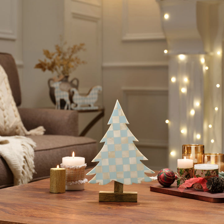 Teal and white checkered bone inlay tree displayed on a festive Christmas mantelpiece