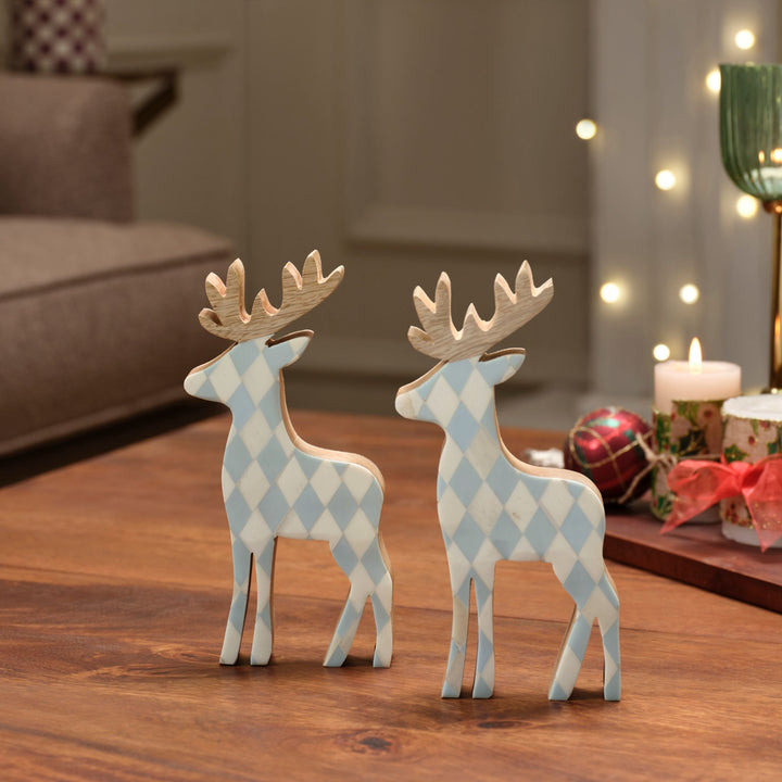  Teal blue and white diamond bone inlay reindeer figurines displayed on a holiday mantelpiece