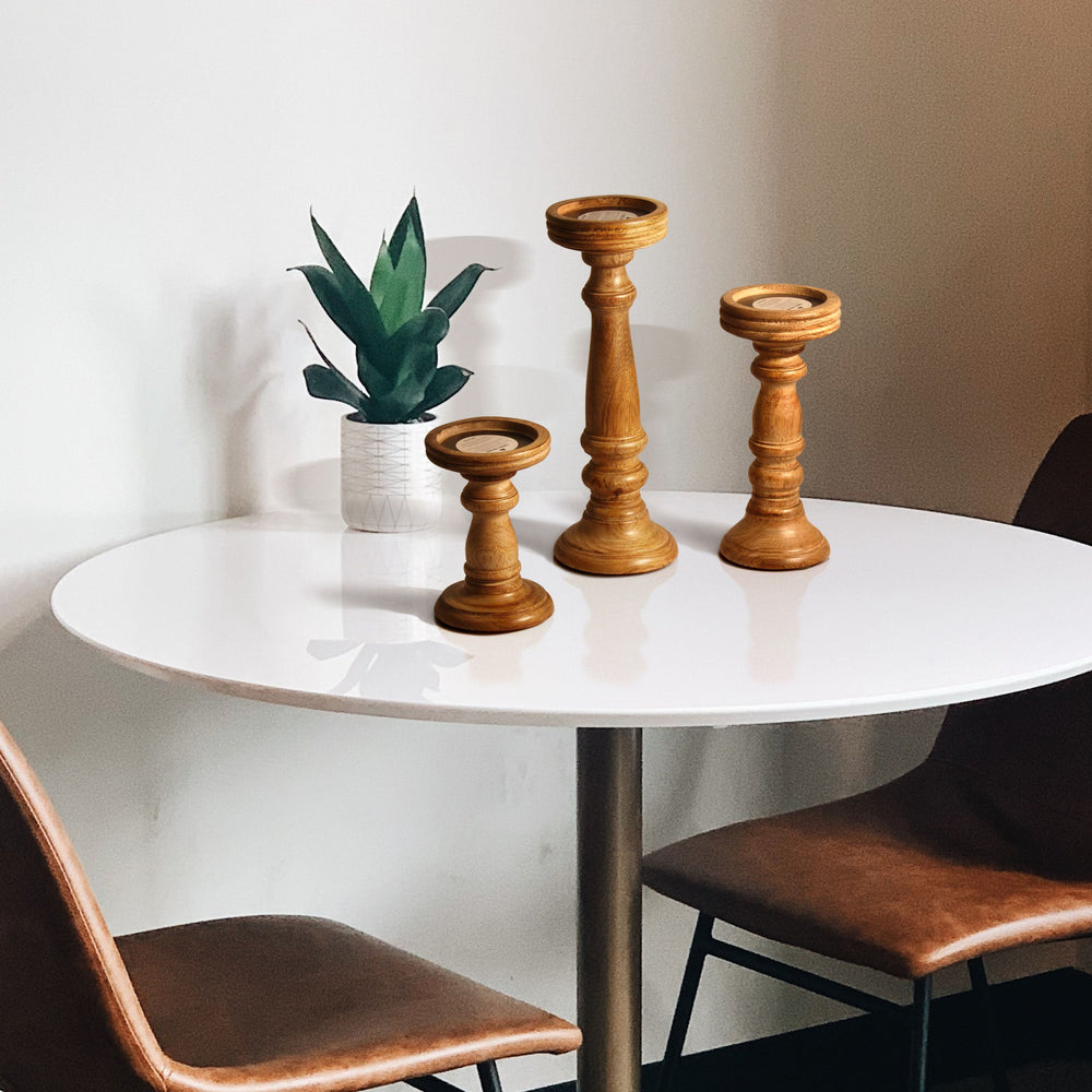 wooden candleholder set styled on table with candles
