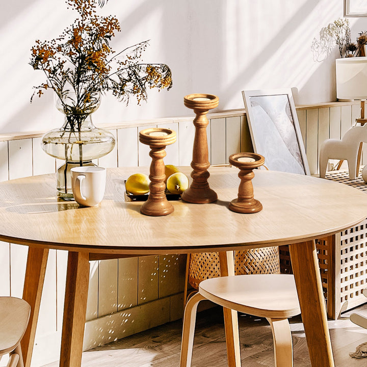 wooden candleholder set styled on table with candles